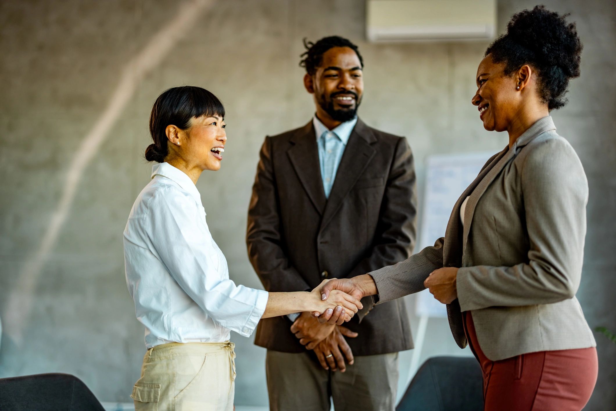 Colleagues greeting each other during an onboarding briefing